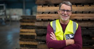 Male factory worker standing with arms crossed